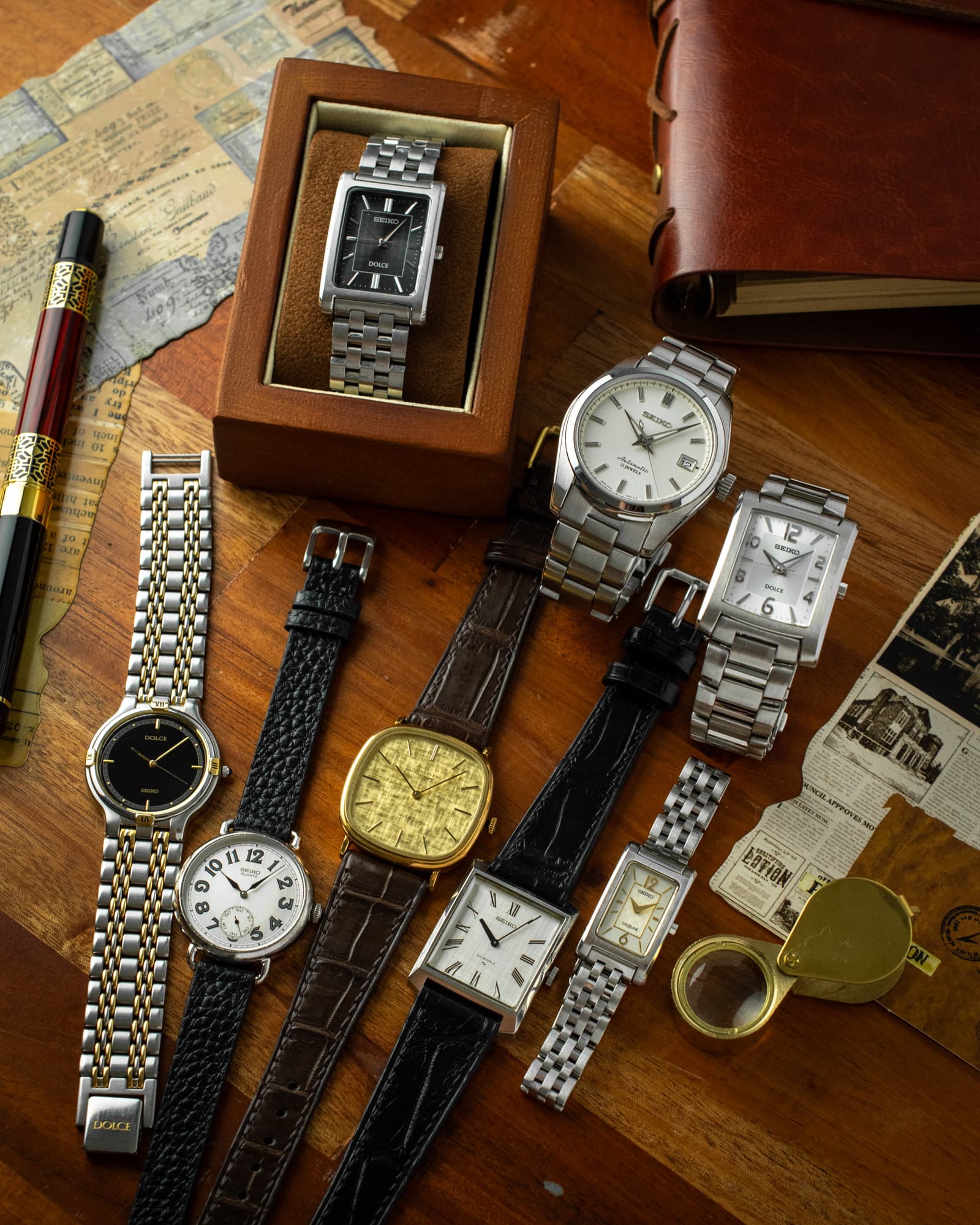 A curated arrangement of vintage watches on a warm wood surface